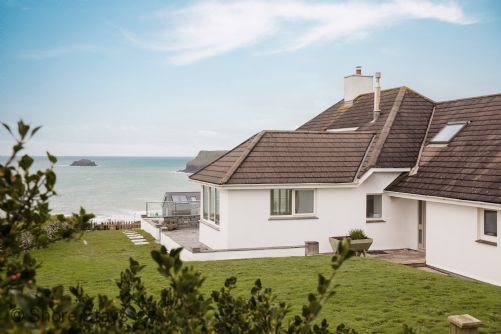 Coastal home with a sloped roof overlooking the ocean.