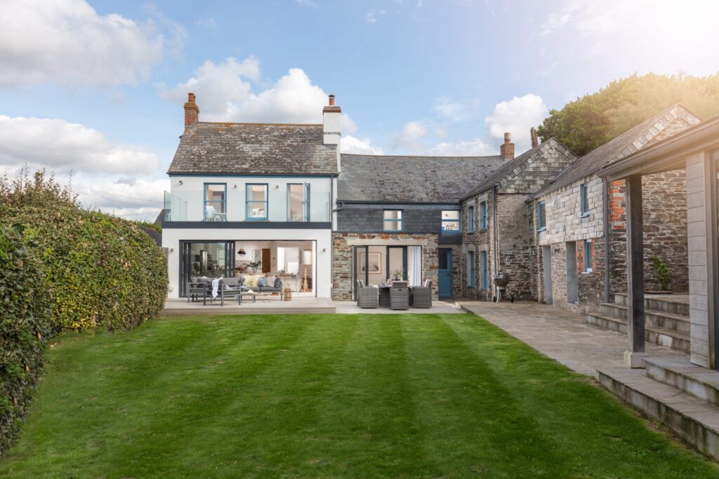 Stone house with modern glass extension.