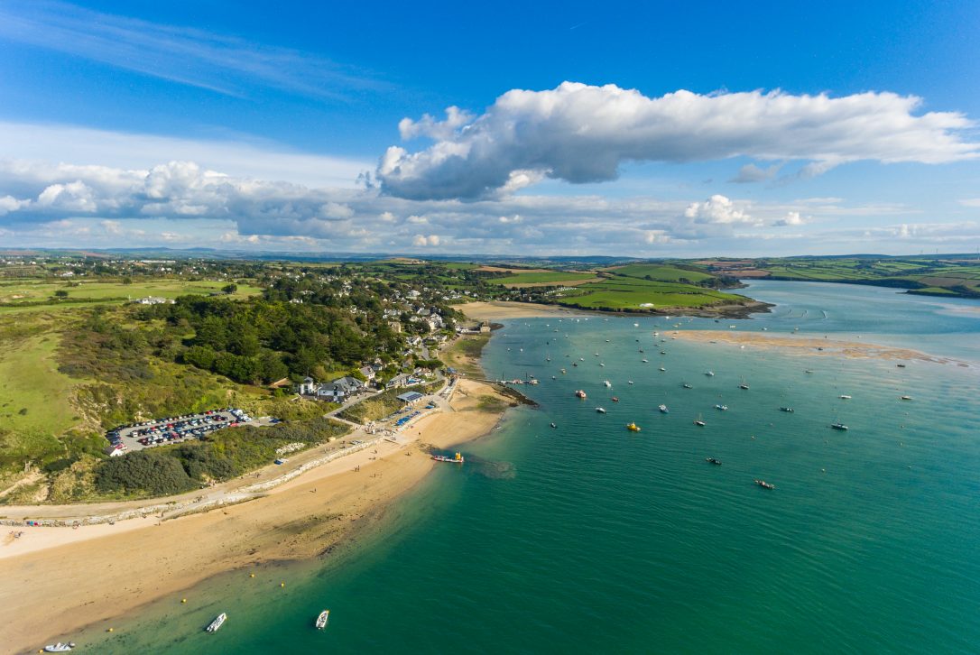A coastal village with sandy beaches and green fields.