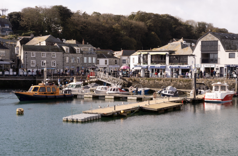 A harbour with small boats docked near a village