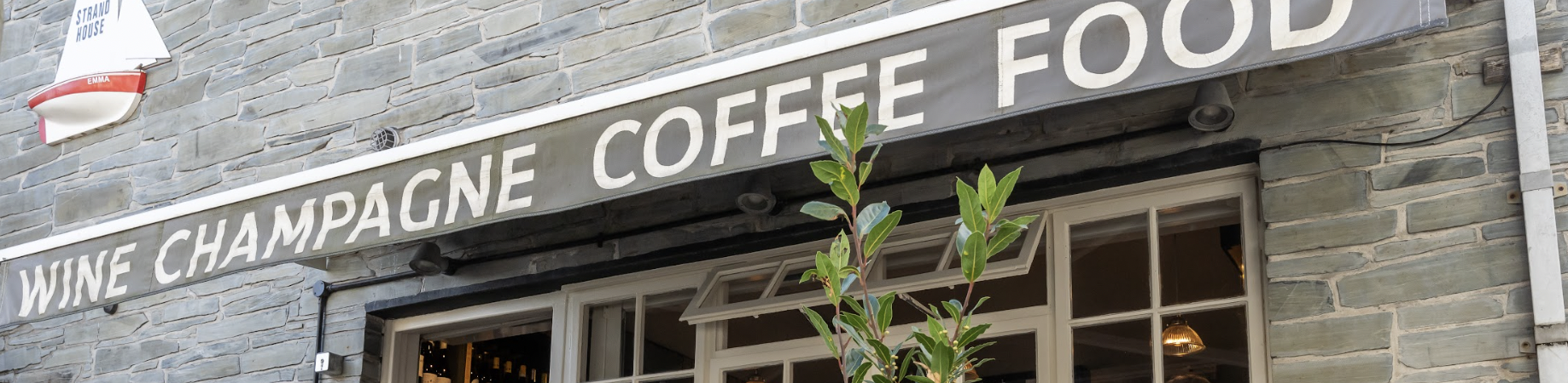 A storefront with a sign reading "Wine Champagne Coffee Food."