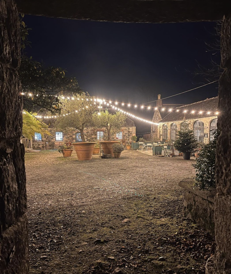 A courtyard at night with string lights