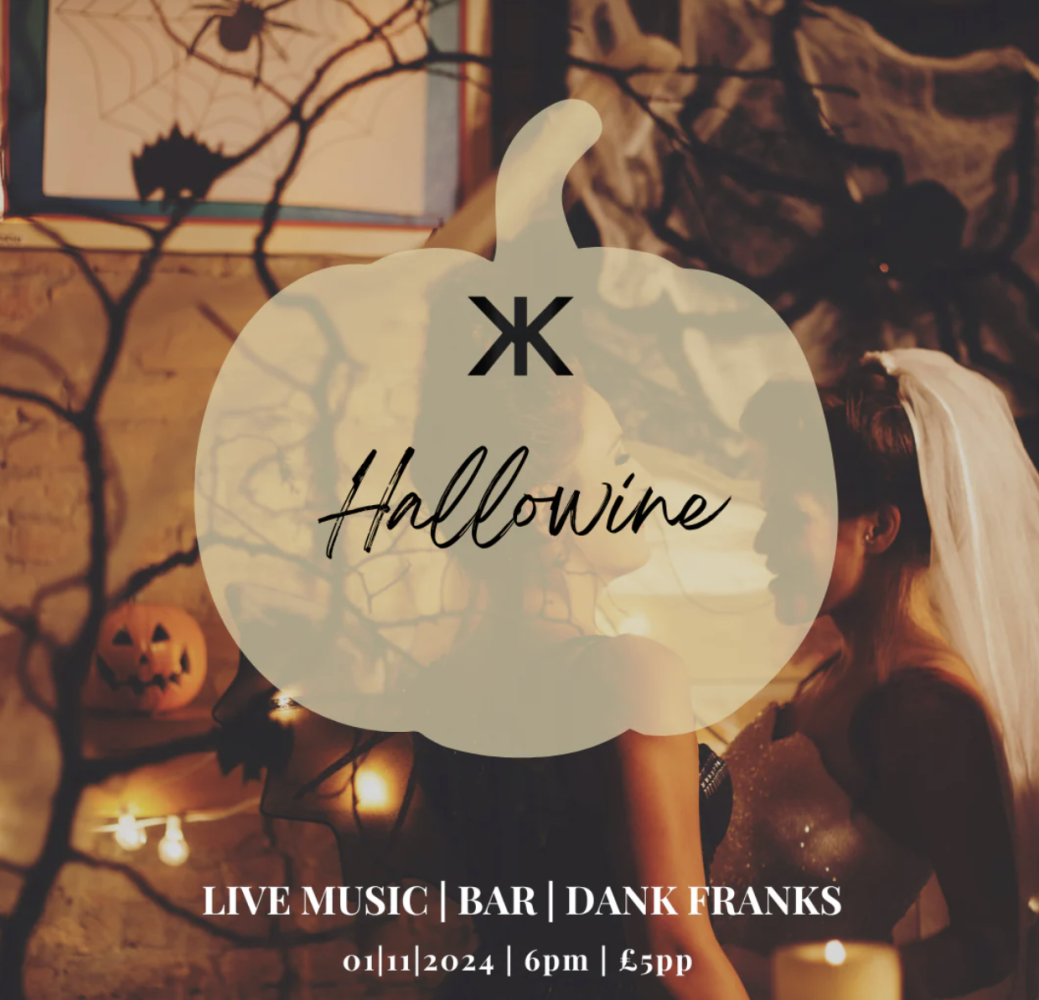 A dimly lit Halloween-themed event poster with spider webs and a pumpkin